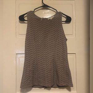 Sleeveless beige work blouse with zig zag fabric pattern